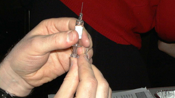 Health worker preparing a meningitis vaccination