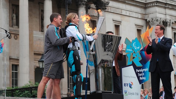 Claire Lomas lighting the flame in Trafalgar Square just before 8.30am