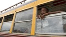  A child looks out of a bus window as residents of a camp for displaced people of the 2010 earthquake evacuate
