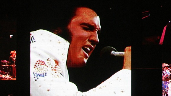A live band backs up a virtual Elvis during a memorial concert of Elvis footage