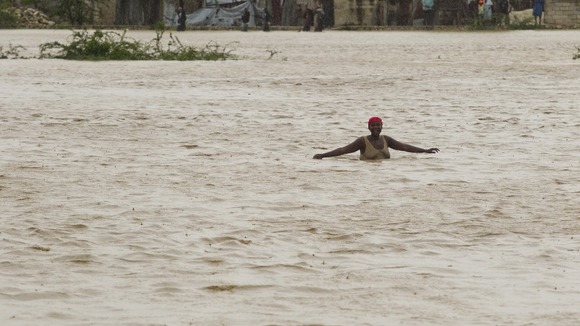 A woman wades through floodwaters in Port au Prince