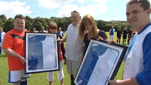 Captain Healey's family holding up shirts