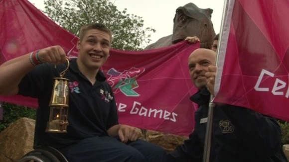 Josh Dunn, Paralympic Torch Ambassador holding the flame at Chester Zoo yesterday (August 27), where hundreds turned out to see it.