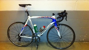 This is a replica of the stolen bicycle described as being a Pinarello Paris - it is red, white and blue. It also has Mr Hindes' name on.