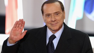 Silvio Berlusconi leaves the conference centre after the first day of the G20 Summit in Cannes in 2011
