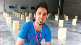 Artist in front of bricks