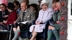 Queen Elizabeth II and the Duke of Edinburgh with the Prince of Wales at the Braemar Gathering.