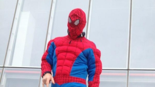 A person wearing a Spiderman fancy dress outfit.