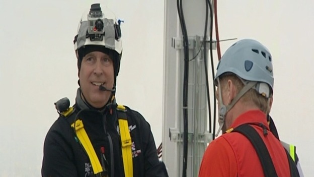 Prince Andrew smiles for the cameras before charity abseil.