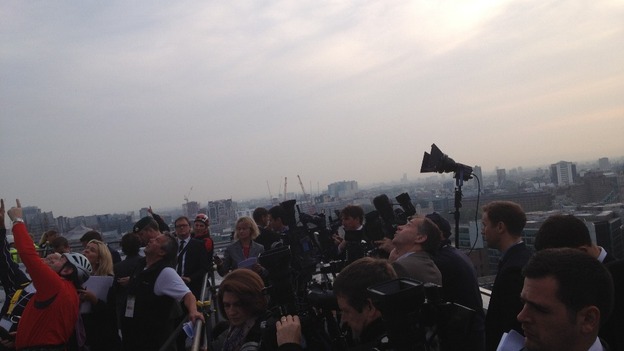 The assembled media direct their camera lenses on The Shard.