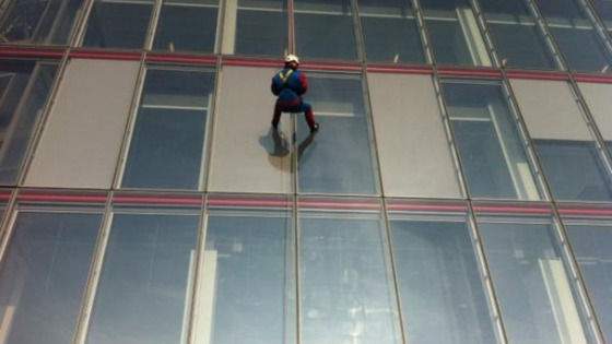A person dressed in a Spider-Man outfit abseils down London's Shard building.