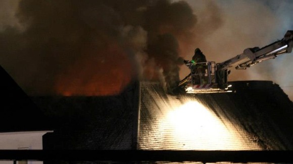 The fire takes hold of the roof space