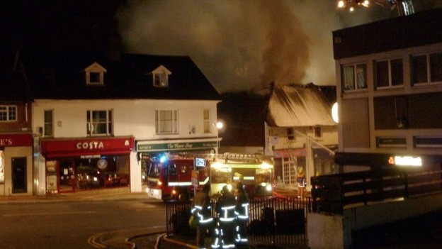 Firefighters stand back as the blaze is bought under control