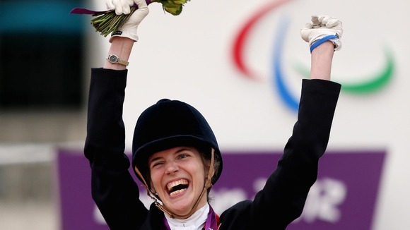 Sophie Christiansen jumps for joy after winning gold.