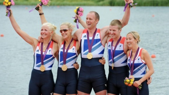 Naomi Riches (with glasses) celebrates on the podium.