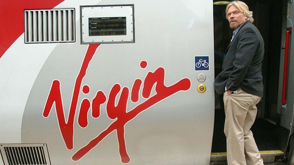 Sir Richard Branson boarding a Virgin train