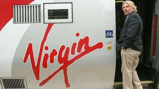 Sir Richard Branson boarding a Virgin train