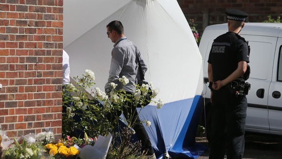 British and French police officers (identities not known) outside the home of French shooting victim, Saad al-Hilli in Claygate.