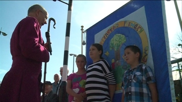 The Bishop of Jarrow blesses one of the specially designed banners
