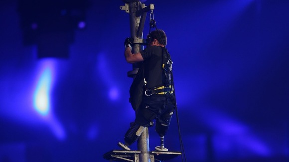 Captain Luke Sinnott climbs a flag pole during the Closing Ceremony