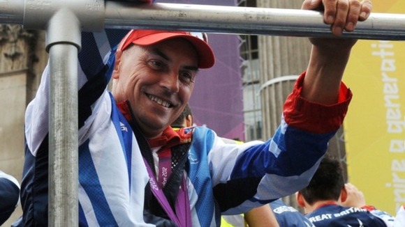 Wheelchair tennis player Peter Norfolk waves to the crowds