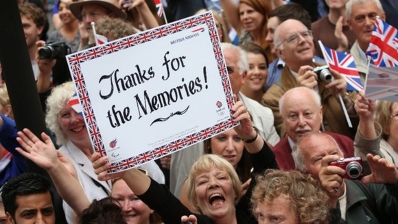 The crowds hold up their custom made signs