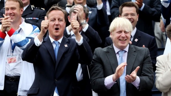 Prime Minister David Cameron and Mayor of London Boris Johnson cheer on the Olympic athletes as they take part in a parade through London
