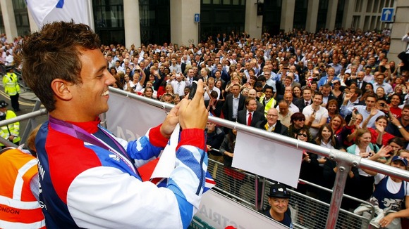 Diver Tom Daley films the crowd.