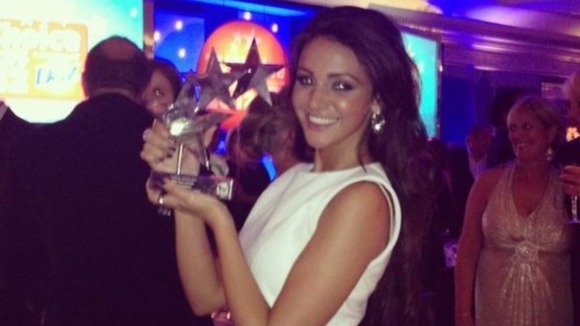Michelle Keegan holds up her Best Soap Actress gong at the TV Choice Awards