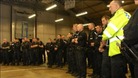 Police photo of officers being briefed before early morning raids