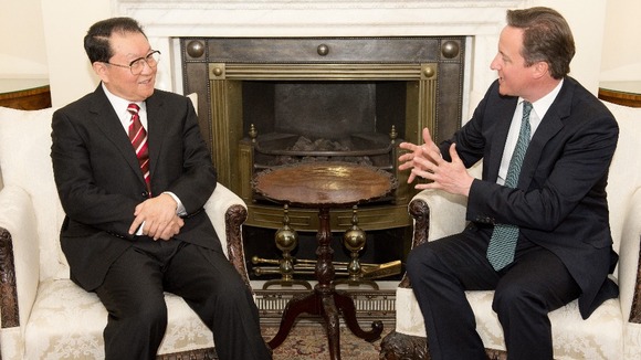 David Cameron talks to a senior official of the Chinese Communist Party, Politburo member Li Changchun