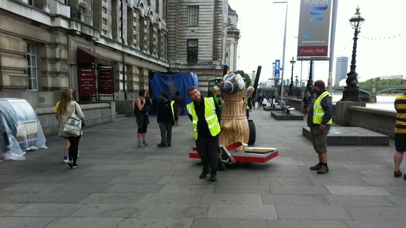 A Mandeville statue is wheeled away from its position on the South Bank.