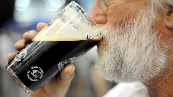 A drinker sups a pint of real ale at last year's Great British Beer Festival