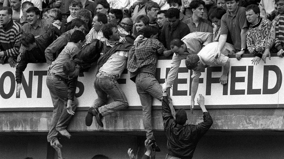 Liverpool fans trying to escape severe overcrowding during the FA Cup semi-final football match against Nottingham Forest at Hillsborough.
