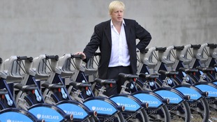 Boris standing next to Barclays bikes
