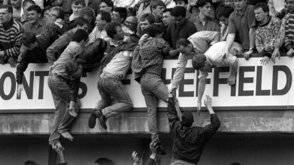 iverpool fans trying to escape severe overcrowding during the FA Cup semi-final football match between Liverpool and Nottingham Forest at Hillsborough.