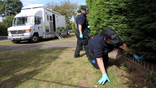 Police search outside the home of Saad al-Halli in Claygate, Surrey.