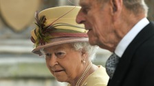 Queen Elizabeth arrives with Prince Philip to address both Houses of Parliament at Westminster Hall in London March 20