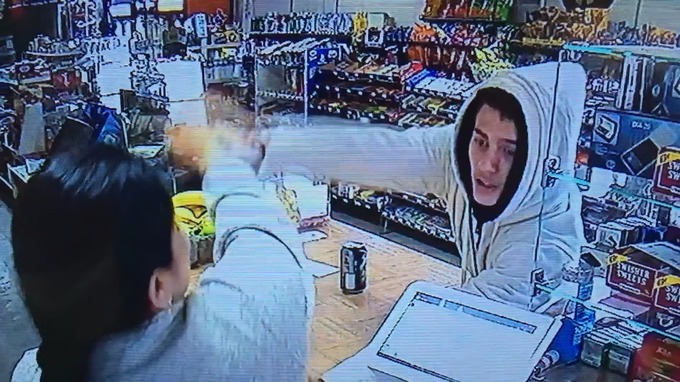 The woman twice slapped his arm away as he pointed the gun at her.