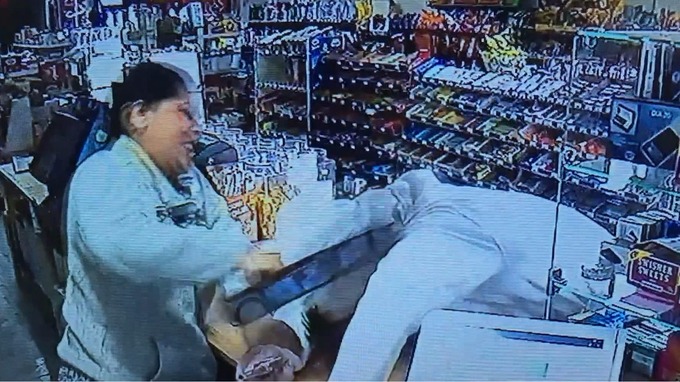 The employee hits the suspect with the till drawer.