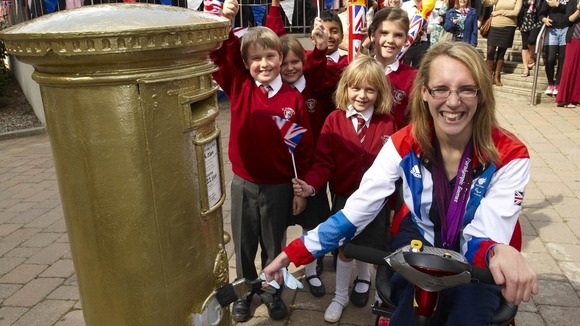 Sophie Christiansen next to gold postbox.
