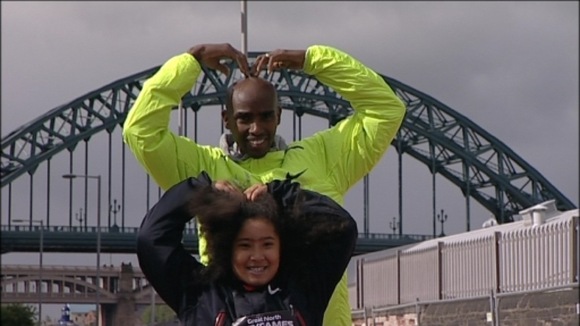 Mo Farah and his daughter doing the famous 'Mo-Bot' celebration in front of the Tyne Bridge