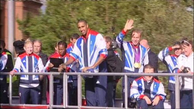 Scottish athletes take part in a parade in Glasgow
