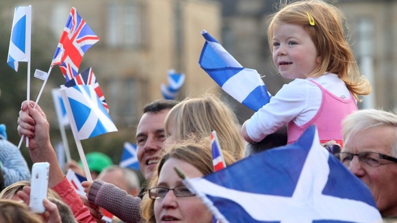 Members of the public watch the official victory parade for Scotland's Olympic and Paralympic teams