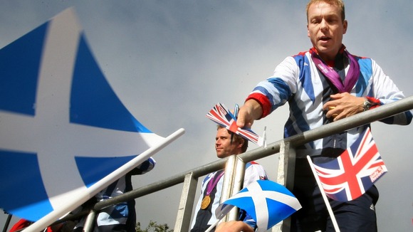 Six-time gold medallist, Sir Chris Hoy signs his autograph during the official victory parade