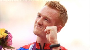 Olympic champ won't be at victory parade