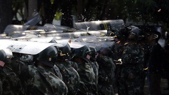 Eggs thrown by demonstrators splatter onto police shields during a protest outside the Japanese embassy in Beijing