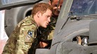 Prince Harry examines the cockpit of an Apache helicopter