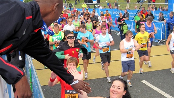 Mo Farah, who was acting as honorary starter, high fives runners during the start of the Great North Run in Newcastle.