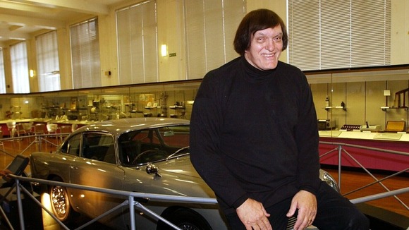 Richard Kiel, who played 'Jaws' in James Bond movies, poses with an Aston Martin